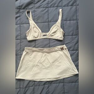 3 piece swimsuit by Calvin Klein. Size 12 on top/bottom & size M on skirt. Used.